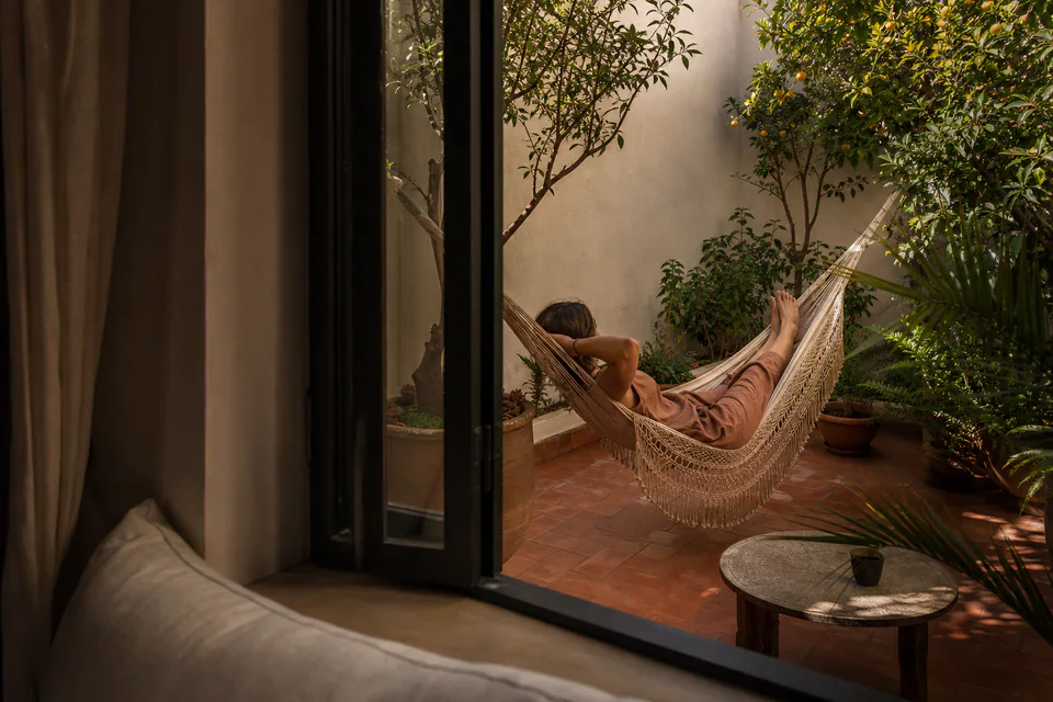 A quiet private patio with a woven hammock